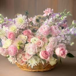 Basket arrangement of pink and white flowers with lavender accents