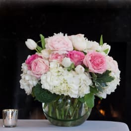 Pink and white rose bouquet in a clear glass vase