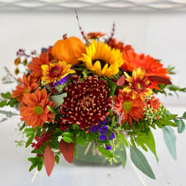 Autumn bouquet with orange and yellow flowers in a vase
