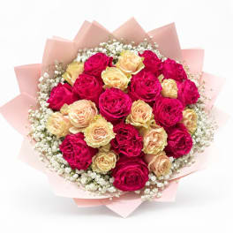Bouquet of pink and peach roses with white filler flowers