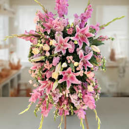 Tall pink floral arrangement with lilies and spray flowers