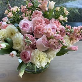 Pink and white floral arrangement in a glass vase