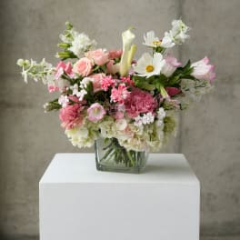 Pink and white mixed bouquet in a square glass vase