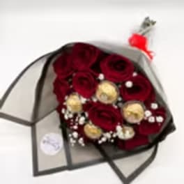 Bouquet of red roses with gold accents wrapped in black paper