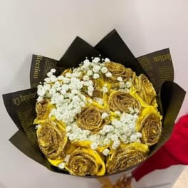 Bouquet of gold roses with white baby's breath in black wrapping