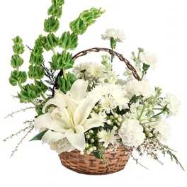 White lilies and chrysanthemums in a wicker basket with tall green spikes