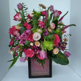 Mixed pink and purple bouquet in a square box