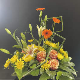 Mixed bouquet with orange gerberas, peach roses, yellow lilies, and chrysanthemums