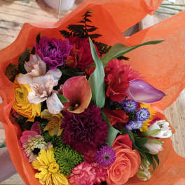 Colorful mixed bouquet wrapped in orange paper