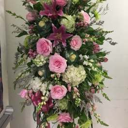 Tall pink and white floral standing arrangement with roses and lilies