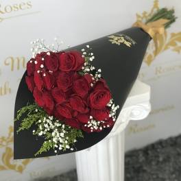 Bouquet of red roses with baby's breath in black wrap