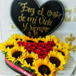 Heart-shaped floral arrangement with red roses and yellow sunflowers