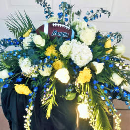 Football-themed floral arrangement with white and yellow flowers