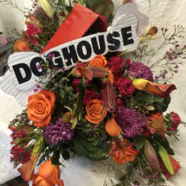 Bright mixed bouquet with roses, calla lilies, and a DOGHOUSE sign