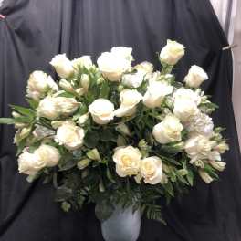 White rose arrangement in a silver pedestal vase
