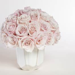 Bouquet of pale pink roses in a white vase