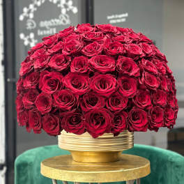 Large dome of red roses in a gold vase