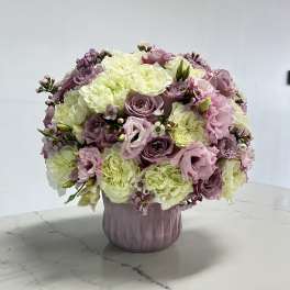 Pink and white bouquet in a lavender vase