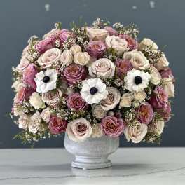 Pink and cream rose bouquet in a gray vase