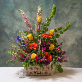 Colorful mixed flower arrangement in a wicker basket