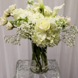 White floral arrangement in a clear glass vase