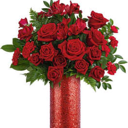 Red roses and alstroemeria in a glittery red vase