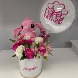 Pink plush toy with roses in a white box and a clear birthday balloon