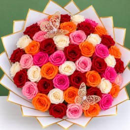 Bouquet of multicolored roses with butterfly decorations