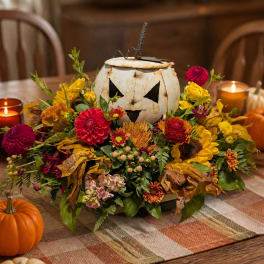 Fall floral arrangement around a white pumpkin centerpiece