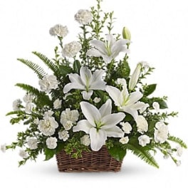 White lilies and carnations in a wicker basket
