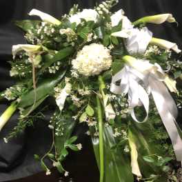 Large white floral spray with calla lilies and ribbon