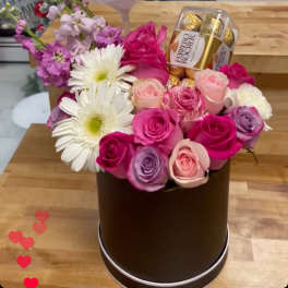 Flower arrangement with a clear balloon reading "I Love You MOM" and chocolates