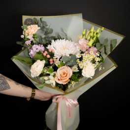 Hand-tied bouquet of peach and white flowers with pink ribbon