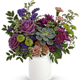 Mixed bouquet in a white vase with purple, pink, and green blooms