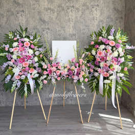 Three pastel floral standing sprays on easels with a blank center panel
