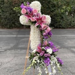 Tall floral standing spray with pink lilies, roses, and white blooms