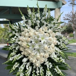 Large white funeral spray with roses and lilies