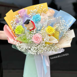 Colorful bouquet with roses, baby’s breath, and a small teddy bear