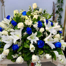 Large bouquet of white lilies and roses with bright blue roses