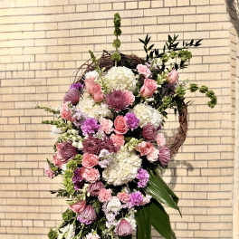 Large cascading floral wreath with pink and white blooms
