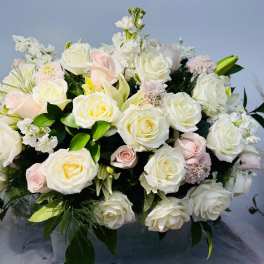 Large bouquet of white and blush roses with white filler flowers