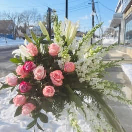 Pink roses and white lilies in a large standing arrangement