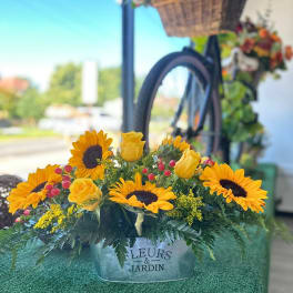Sunflower and yellow rose arrangement in a metal container