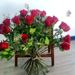 Large bouquet of red roses with greenery and filler