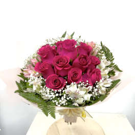 Bouquet of hot pink roses with white accent flowers