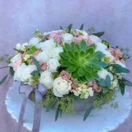 Round bouquet of white and blush roses with a green succulent centerpiece