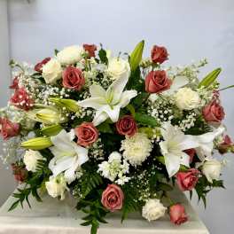 Large bouquet of white lilies and pink roses with baby's breath