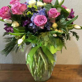 Pink and purple mixed bouquet in a clear glass vase