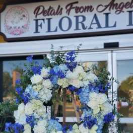 Large blue and white floral wreath on an easel