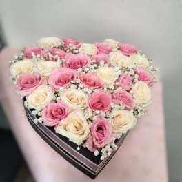 Heart-shaped box filled with pink and white roses